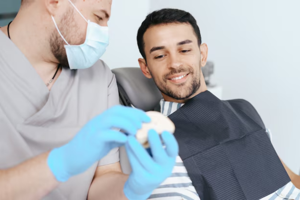 dentist examining a missing tooth before recommending a bridge