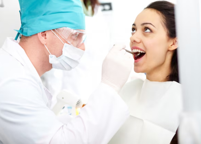 dentist examining a missing tooth before recommending a dental bridge